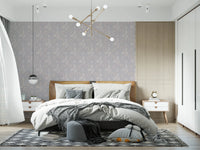 Serene Floral beige wallpaper behind a tan leather headboard with grey bedding and a black globe pendant in a bedroom