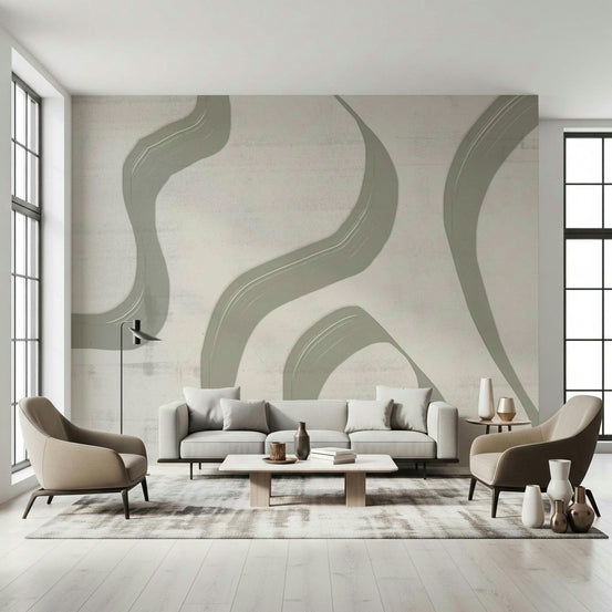 Subtle Stream wallpaper mural with sage green wavy lines on cream behind a grey sofa and two taupe armchairs
