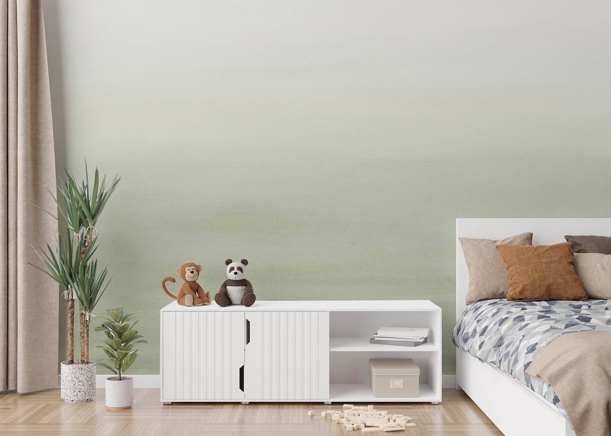 Serene Green watercolor wallpaper mural in soft sage behind a white sideboard with plush toys in a kids bedroom