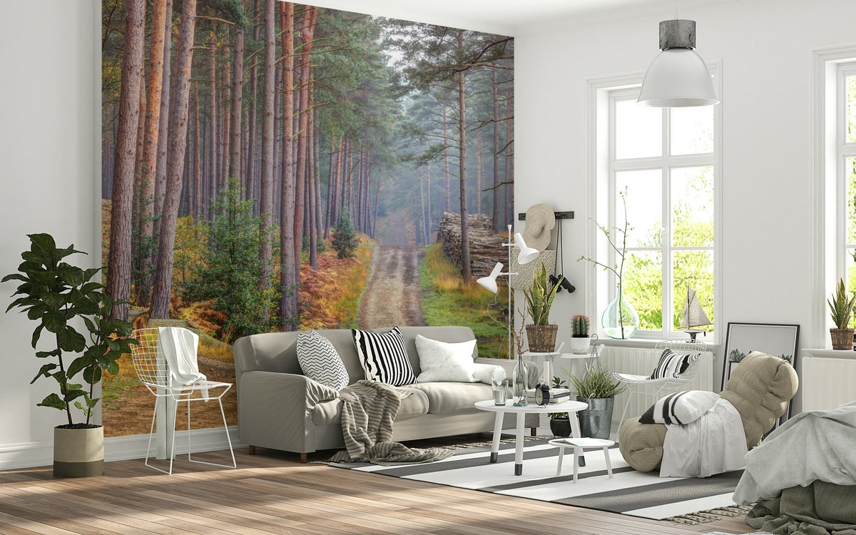 Serene Road Through Autumn Splendor wallpaper mural with misty pine forest path behind a gray sofa in a bright living room