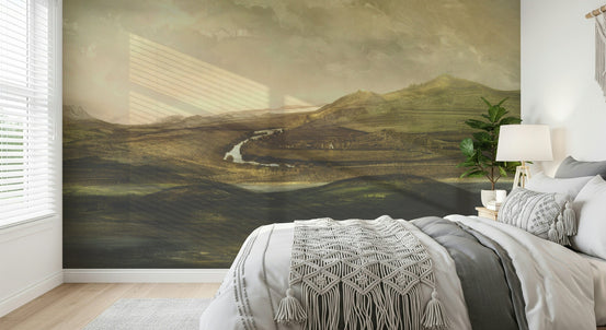 Painted Valley Vista wallpaper mural of a river valley in a bedroom with gray bedding and a macrame throw