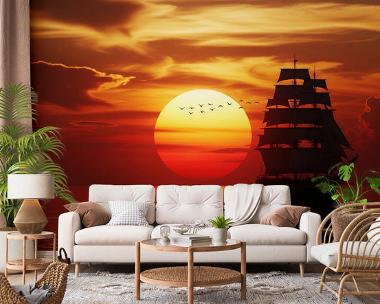 Setting Sun Sail wall mural with a tall ship and glowing red sunset behind a white sofa in a living room