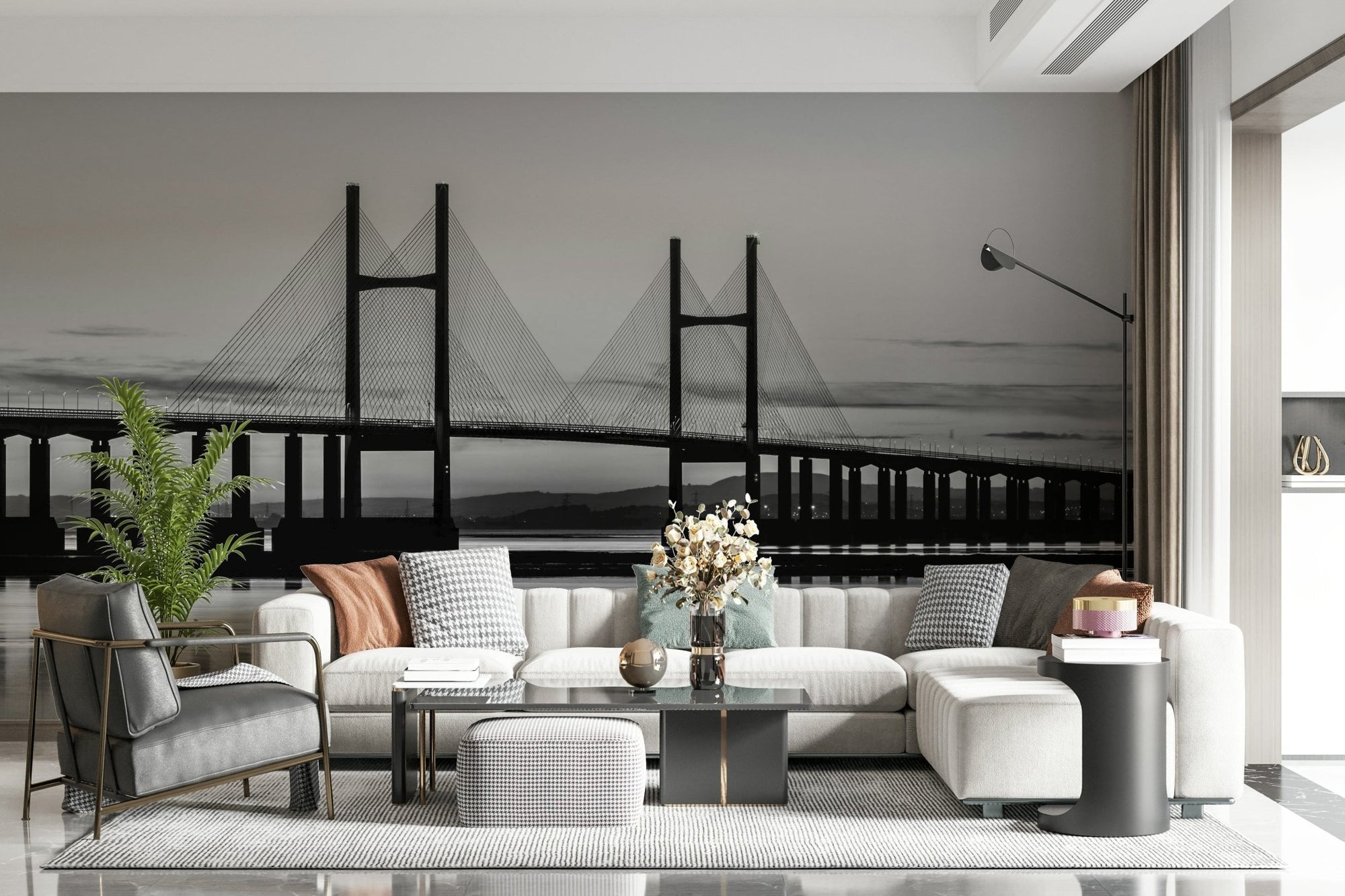 Severn Bridge black and white wall mural above a cream sectional sofa and gray armchair in a living room