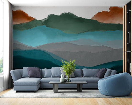 Watercolor Abstract Highland wallpaper mural of teal and green mountains behind a grey sectional and blue beanbag