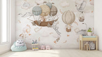 Cloud-Hopping Critters wallpaper mural of critters in balloons above a mint bean bag and play table in a nursery