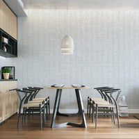 Neutral grey wallpaper mural with abstract tribal script.
