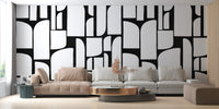 Monochrome Mosaic Tiles wallpaper mural in black and white behind a beige sectional sofa in a living room