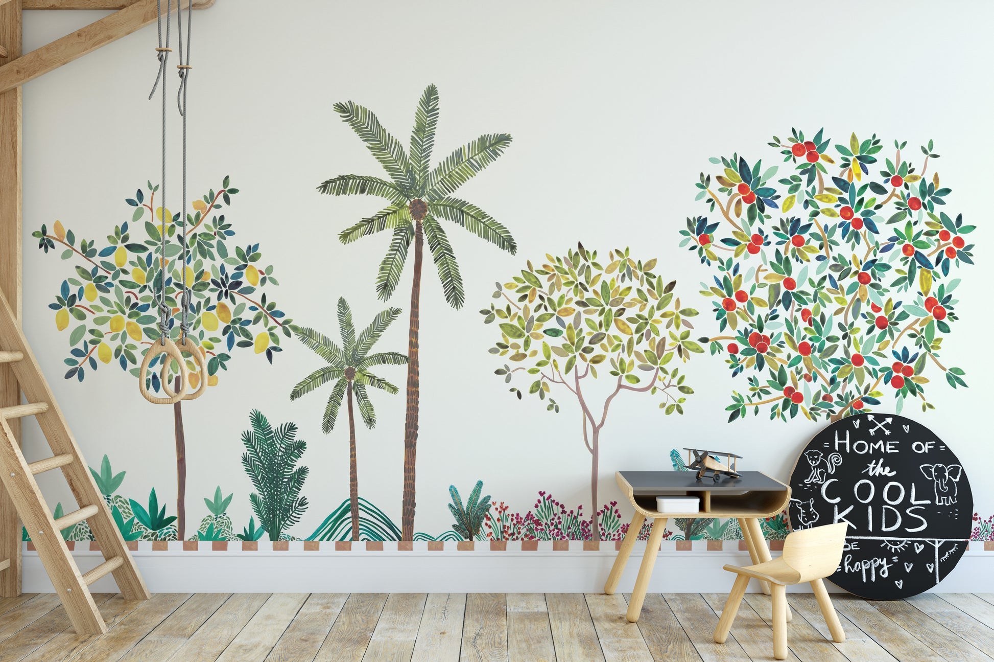 Colorful Tree Wall mural with lemon and berry trees in a kids room with a black desk and small chair