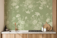 Green Floral wallpaper mural in muted green behind a white sofa and round coffee table in a bright living room