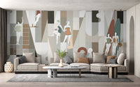Modern Mosaic Wearables wallpaper mural of geometric shapes and swimmer figures behind a beige sectional in a living room