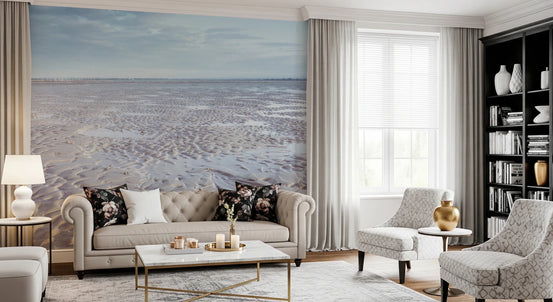 Shoreline Serenity wallpaper mural of a calm rippled sand beach behind a cream tufted Chesterfield sofa with floral cushions