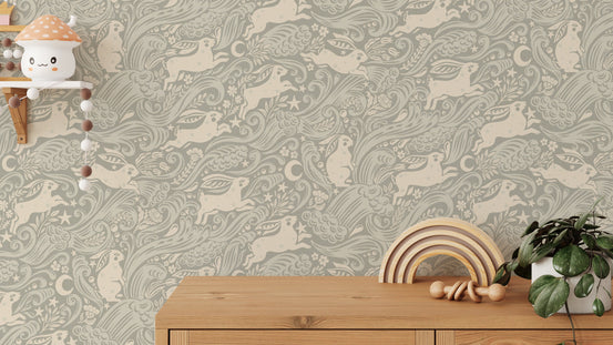 Silver Celestial Sea Rabbit wallpaper of cream rabbits and moons on sage in a nursery with a wooden rainbow toy