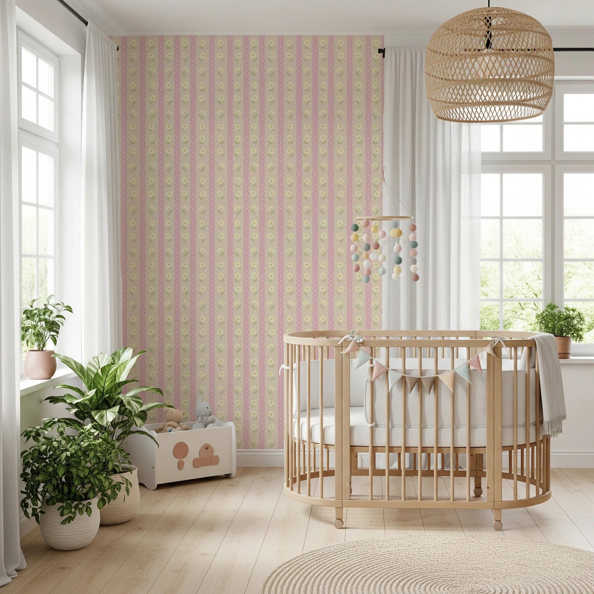 Soft Bloom Stripes wallpaper mural in a nursery behind a wood crib with pennant bunting and leafy plants