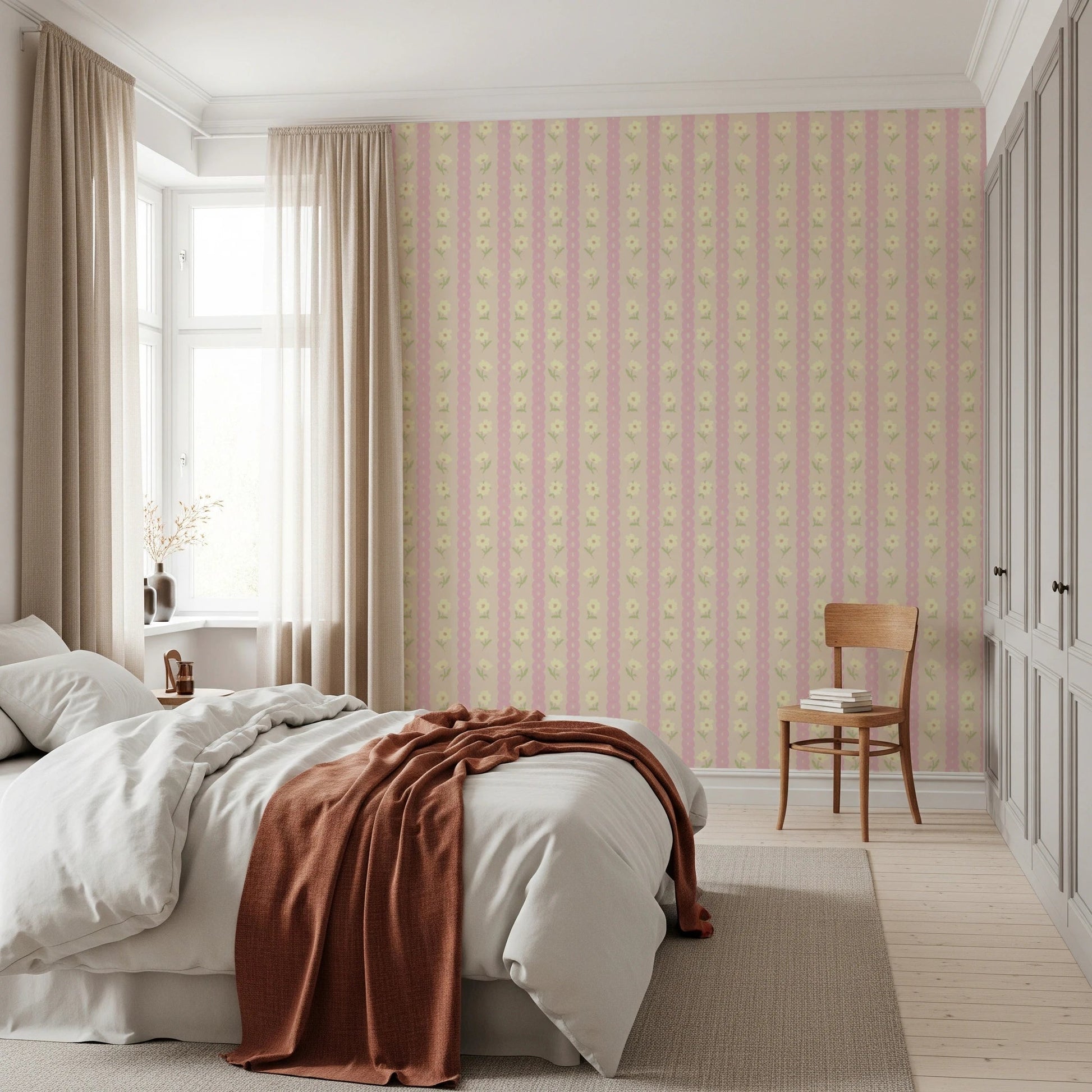 Soft Bloom Stripes wallpaper mural in a bedroom with a white bed and rust throw, pink and yellow floral stripes