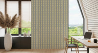 Soft Daisy Stripes wallpaper with sage and grey daisy stripes behind a wood desk and black chair in a bright home office