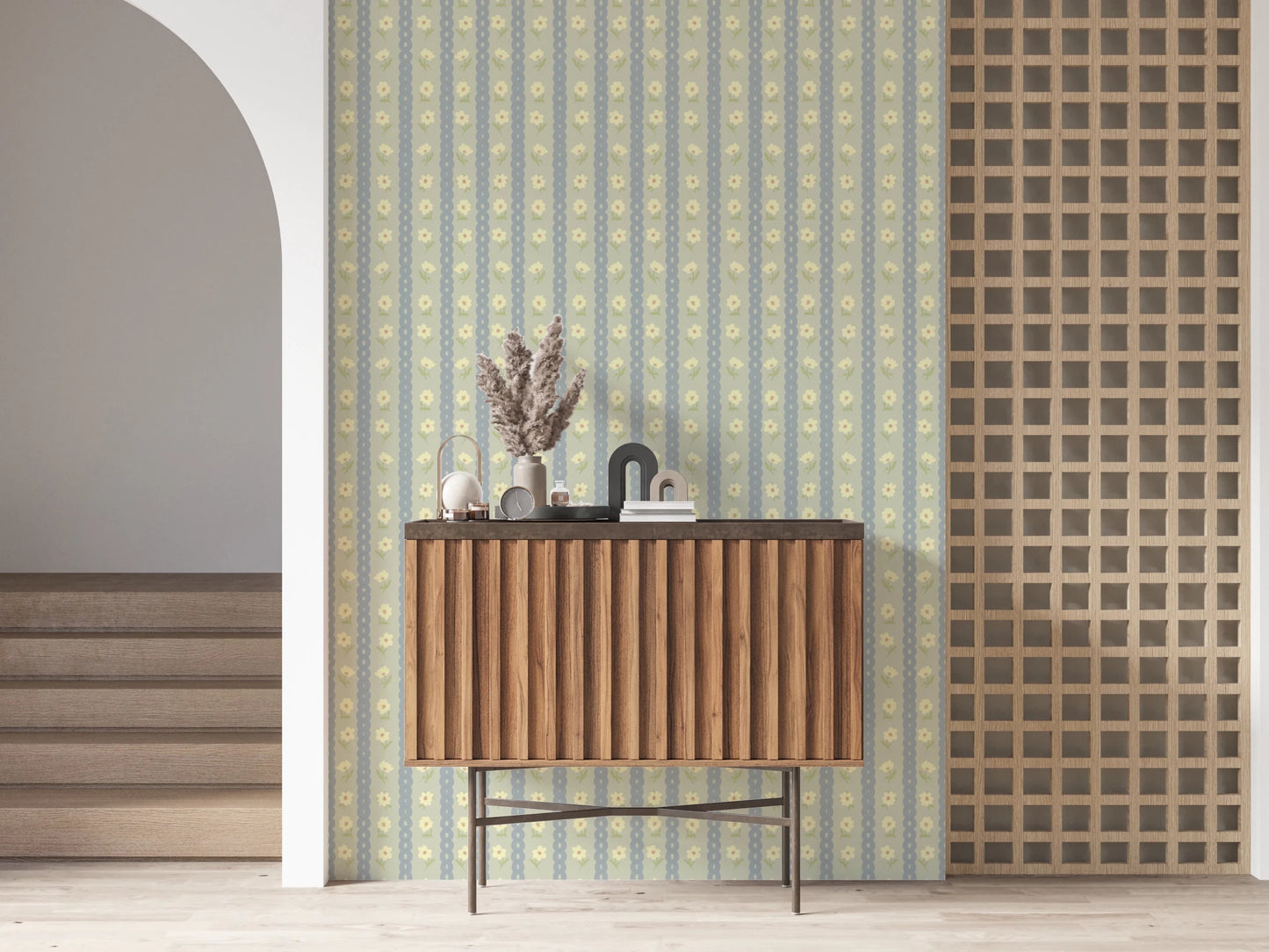 Soft Daisy Stripes wallpaper in green and blue daisy stripes behind a fluted wood console in an arched hallway