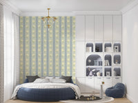Soft Daisy Stripes wallpaper with sage and blue daisy stripes above a round navy bed in a child's room with arched shelving