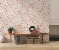 Soft Floral Pink Meadow wallpaper mural in pink florals behind a wood console with vinyl records and baskets in an entryway