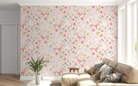 Soft Floral Pink Meadow wallpaper mural of pink daisies behind a cream sofa with grey pillows and a fern in a living room