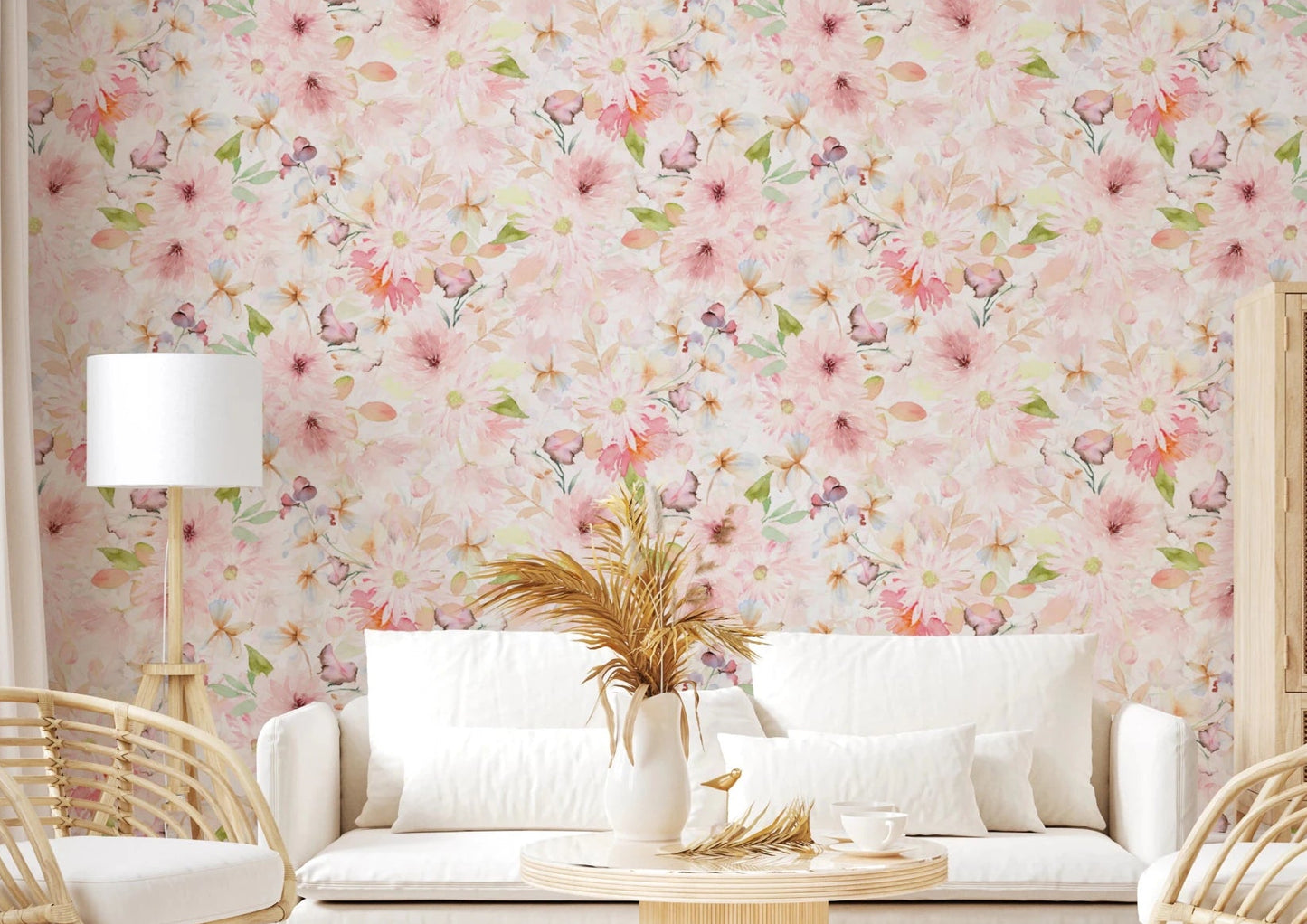 Soft Floral Pink Meadow wallpaper mural with watercolor pink daisies behind a white sofa and rattan chairs in a living room