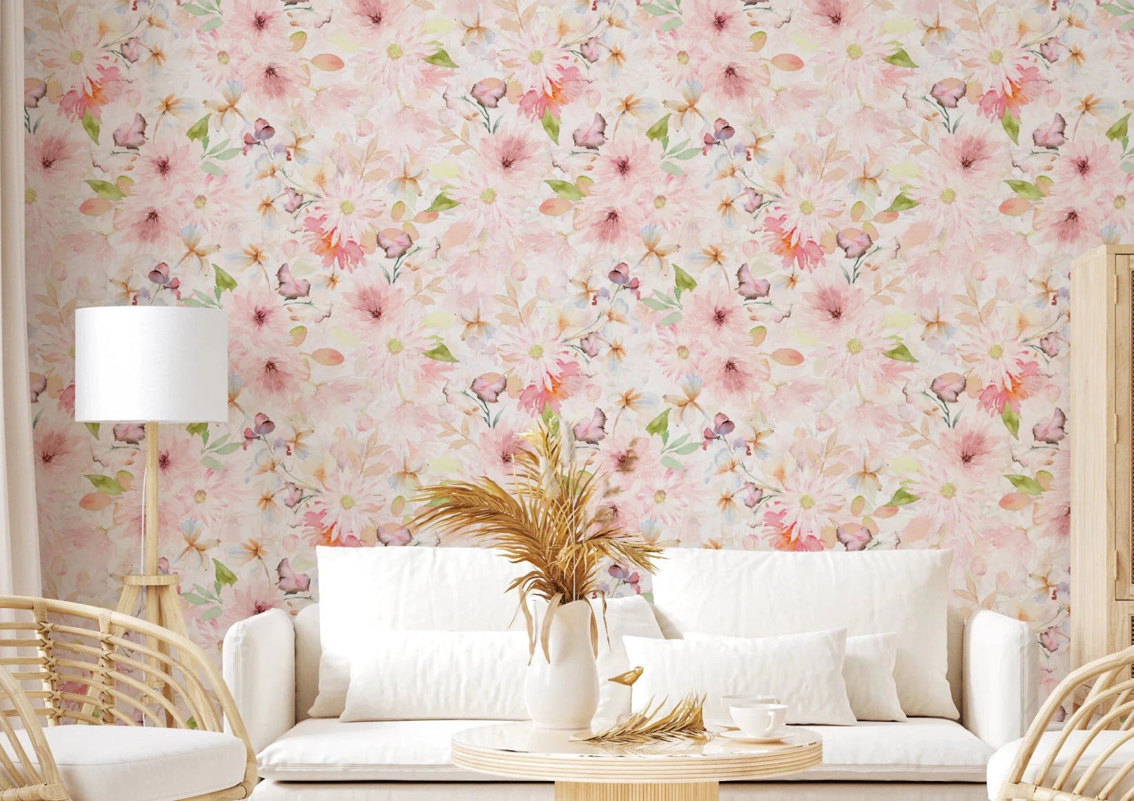 Soft Floral Pink Meadow wallpaper mural with watercolor pink daisies behind a white sofa and rattan chairs in a living room