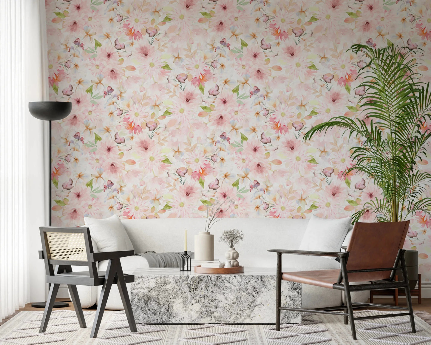 Soft Floral Pink Meadow wallpaper mural of blush daisies above a white sofa, marble table and leather chair in a living room