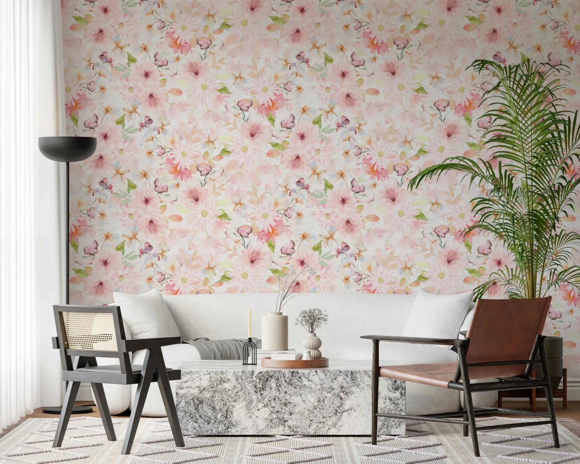 Soft Floral Pink Meadow wallpaper mural of blush daisies above a white sofa, marble table and leather chair in a living room