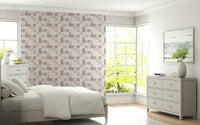 Soft Mosaic Tiles Blush Beige-GreyBlue wallpaper behind a white bed and grey dresser by bay windows