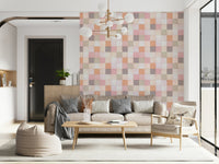 Soft Mosaic Tiles Peach Glow wallpaper behind a beige sofa with beanbag and globe chandelier