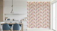 Soft Mosaic Tiles Peach Glow wallpaper beside a kitchen counter with blue chairs at a wood table