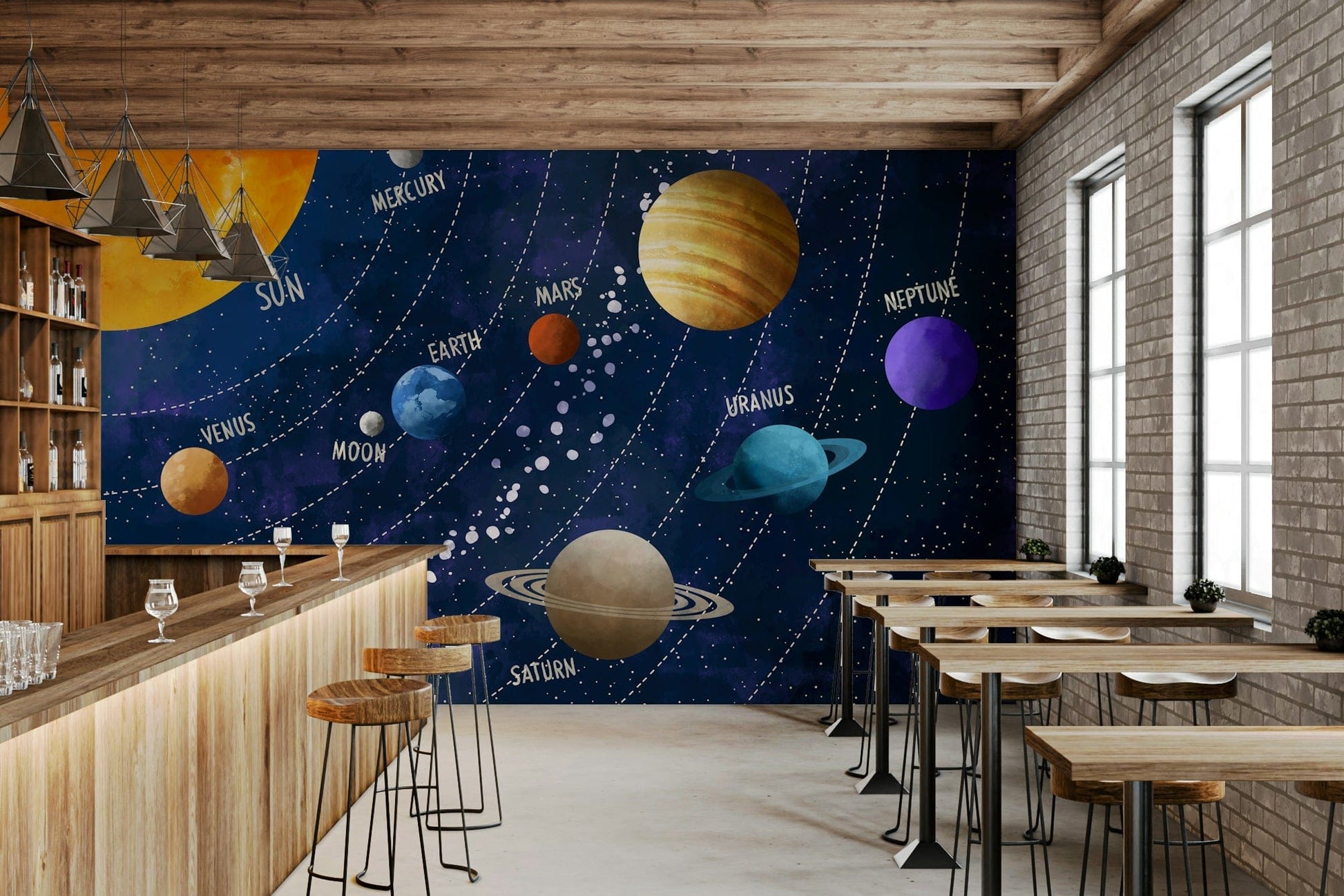 Solar System Adventure wallpaper mural of the labeled planets behind a wood bar counter with stools and brick wall in a cafe
