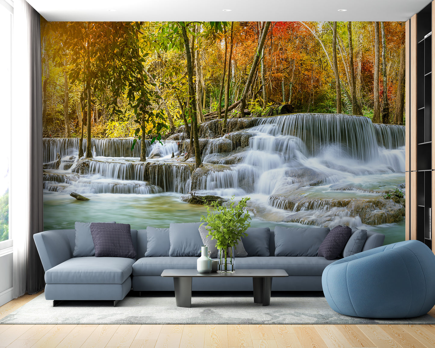 Natural Sparkling Waterfall Jungle wallpaper mural as a bedroom feature wall behind the headboard in blue tones