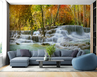 Natural Sparkling Waterfall Jungle wallpaper mural as a bedroom feature wall behind the headboard in blue tones