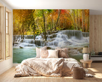 Natural Sparkling Waterfall Jungle wallpaper mural styled as a living room feature wall behind a sofa and seating