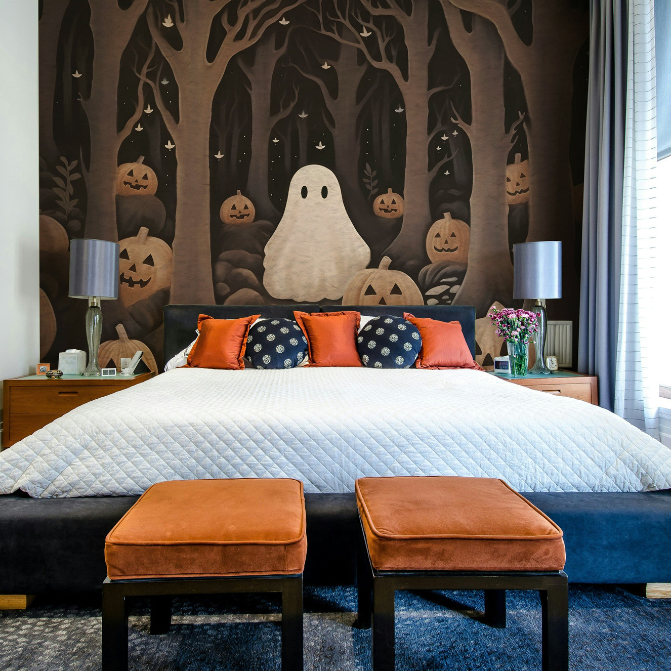 A peaceful wall mural with a whimsical ghost and pumpkins.

