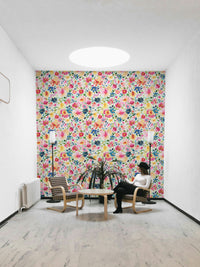 Bright and cheerful spring wallpaper with zinnias and lush leaves.


