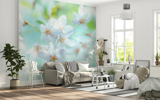 Springtime Blossoms wallpaper mural of dreamy white flowers behind a taupe sofa and white wire chair
