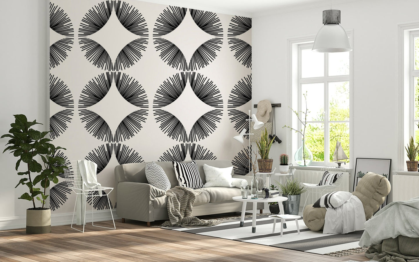 Starburst Deco wallpaper of black starbursts on cream behind a grey sofa with striped cushions and beanbag