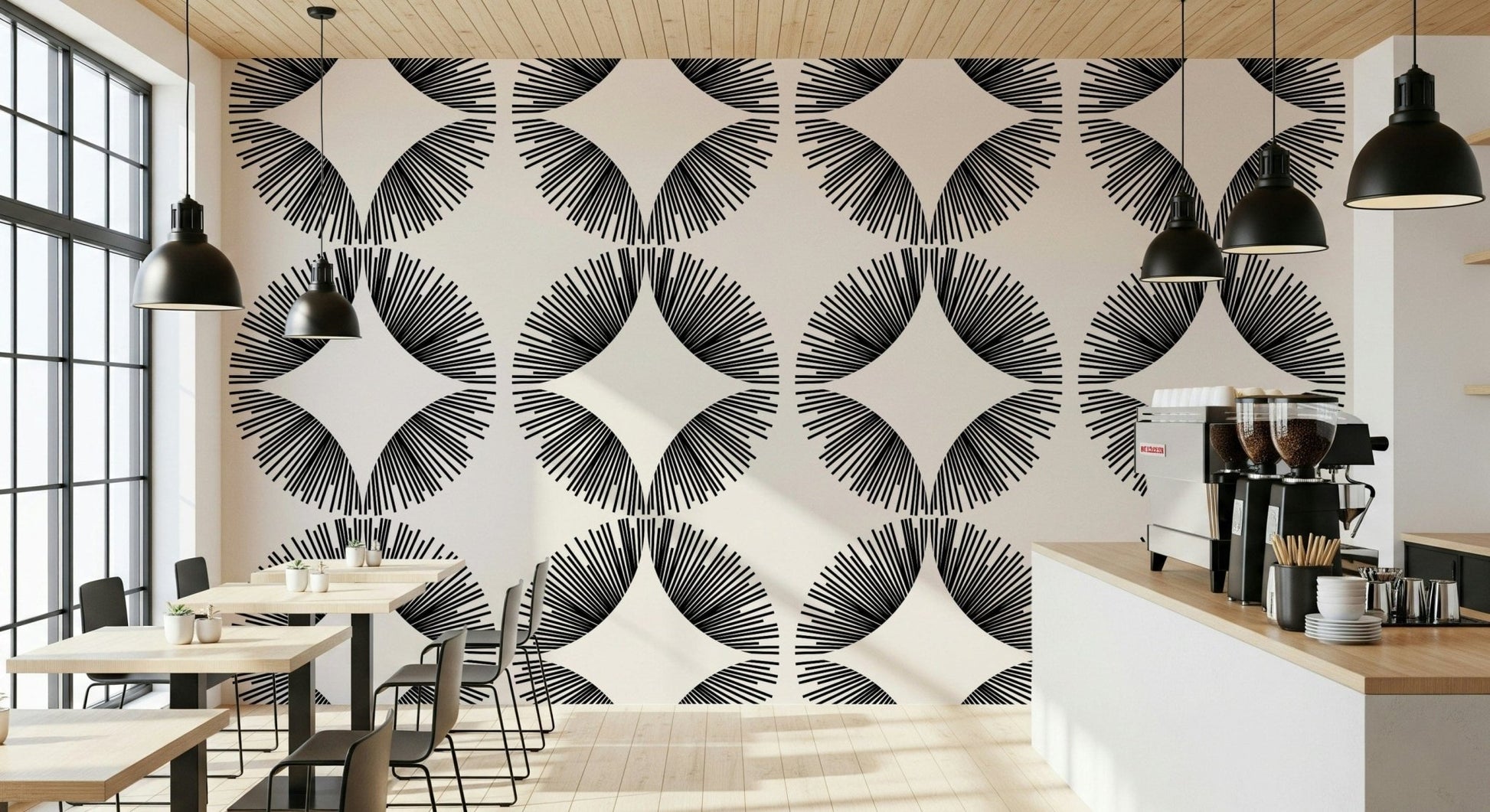 Starburst Deco wallpaper of black sunburst fans on cream in a cafe with wood tables and an espresso machine