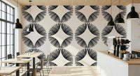 Starburst Deco wallpaper of black sunburst fans on cream in a cafe with wood tables and an espresso machine