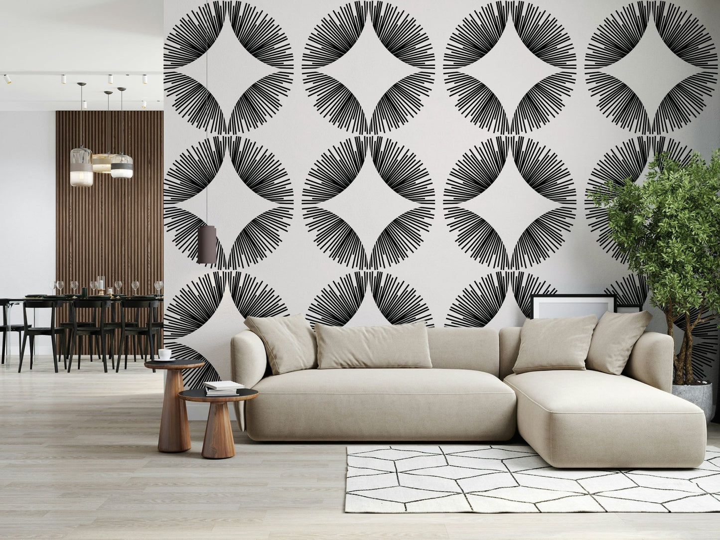 Starburst Deco wallpaper of black sunburst fans on cream behind a cream sectional near a dark dining area
