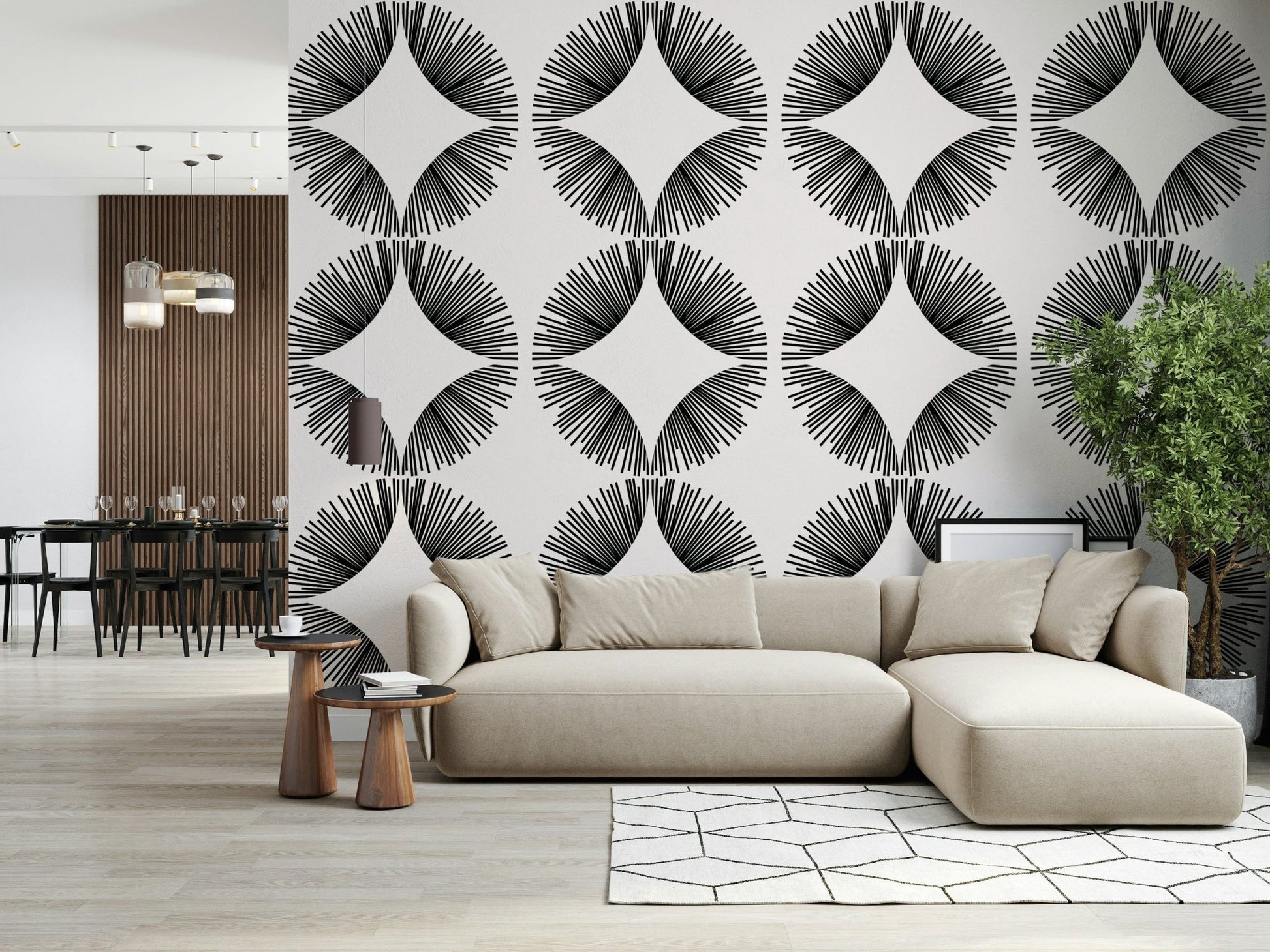 Starburst Deco wallpaper of black sunburst fans on cream behind a cream sectional near a dark dining area