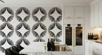 Starburst Deco wallpaper of black sunburst fans on cream beside a white marble island with black bar stools