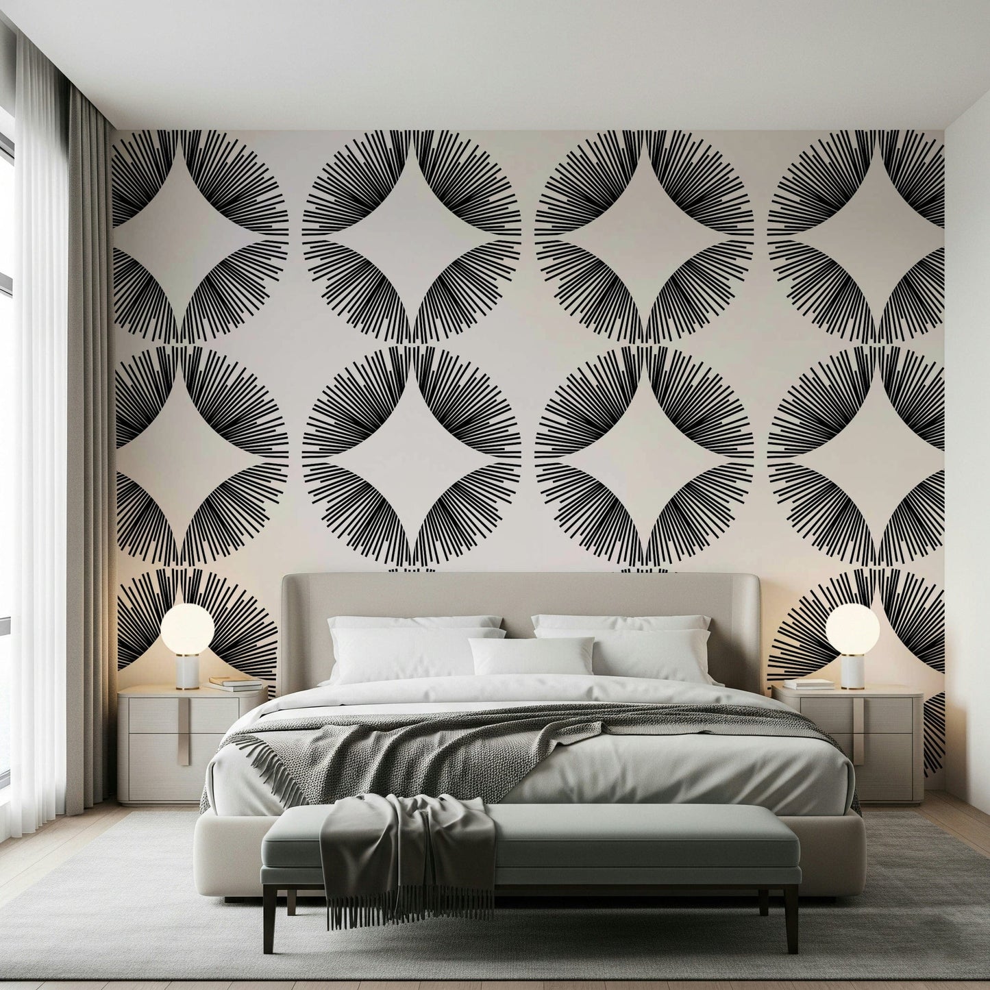 Starburst Deco wallpaper of black sunburst fans on cream behind a beige bed with globe lamps and a bench