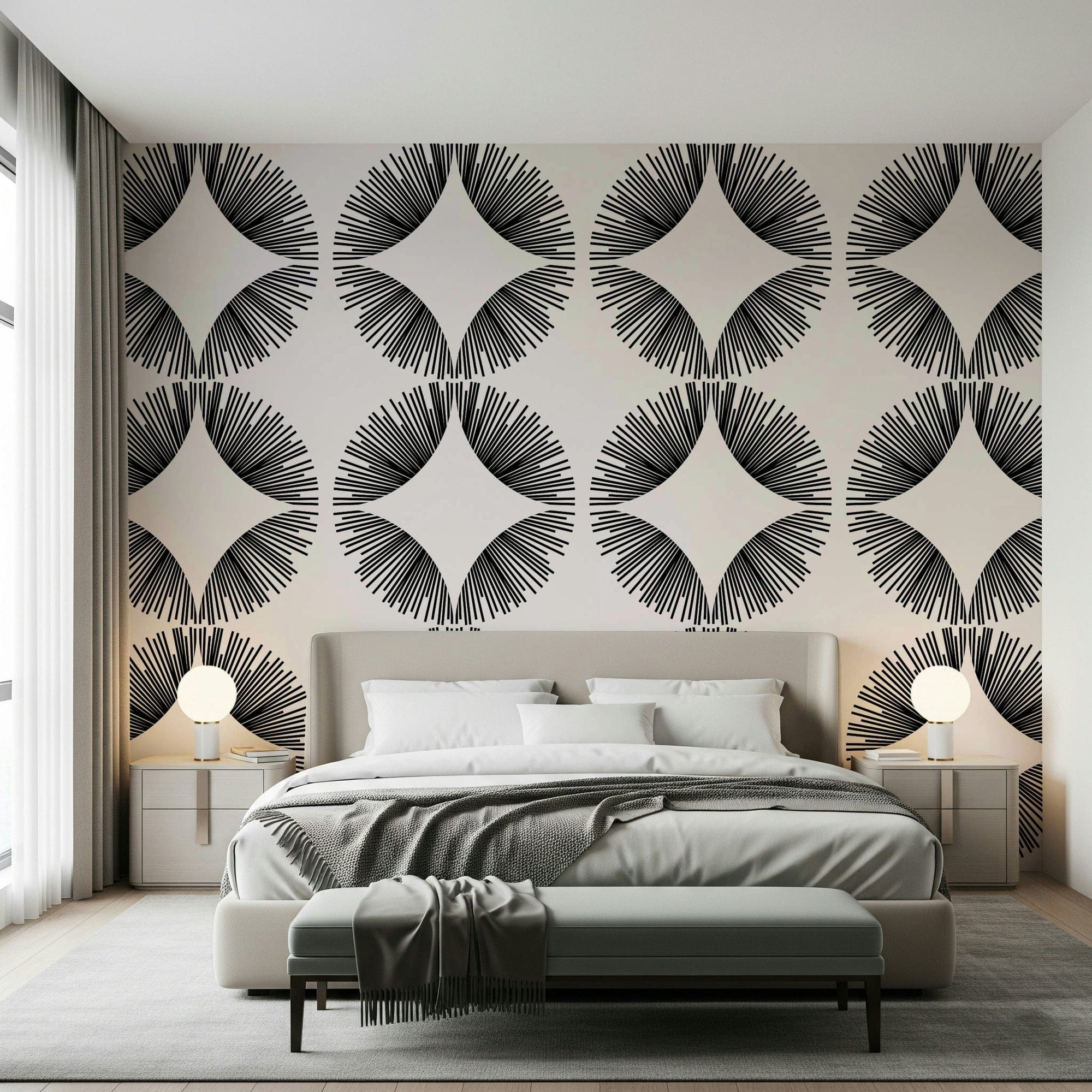Starburst Deco wallpaper of black sunburst fans on cream behind a beige bed with globe lamps and a bench