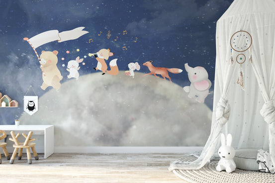 Stardust Dreams wallpaper mural with animals parading over the moon above a white desk and bunny toy in a kids room