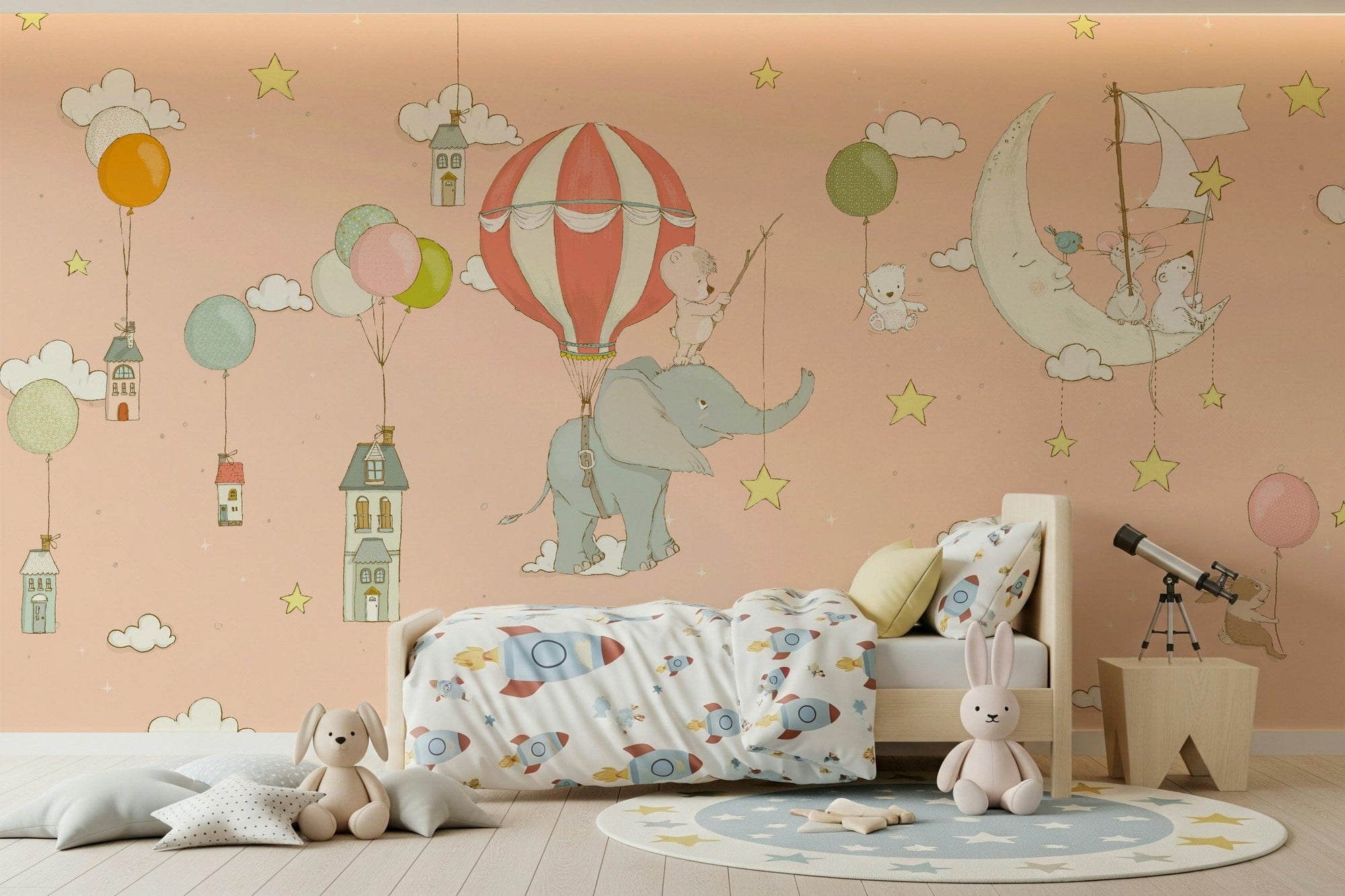Starry Sky Adventures wallpaper mural of a teddy on an elephant and balloon in a peach sky over a wood bed with rocket bedding