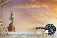 Statue of Liberty wallpaper with sunset sky behind a wooden kids table and cool kids chalkboard sign