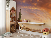 Statue of Liberty wallpaper with sunset sky behind a white desk and wooden house bookshelf in a kids room