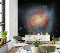 Stellar Canvas wallpaper mural of a glowing galaxy behind sage green chairs and a white sideboard in a living room